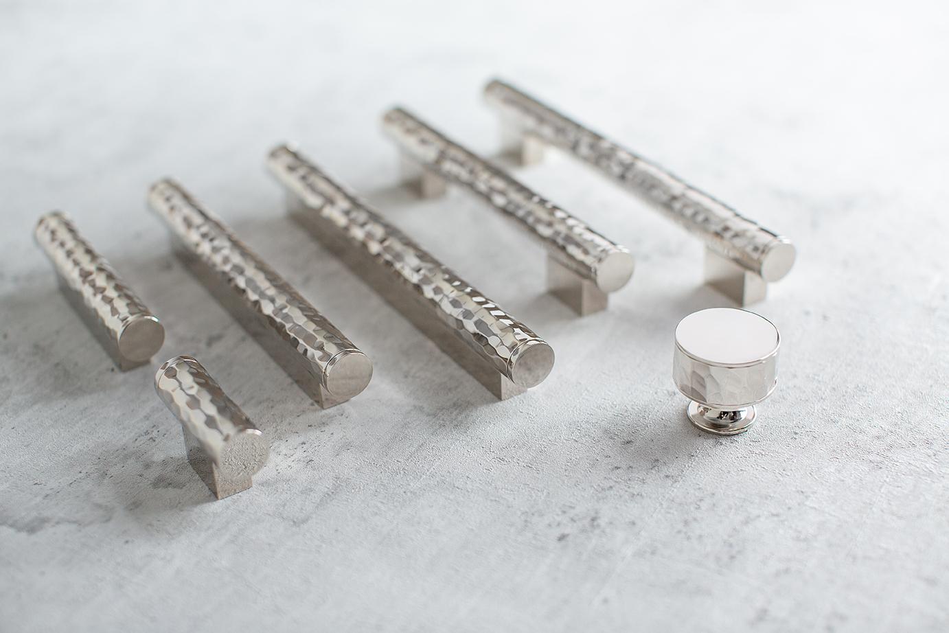 Image shows a collection shot of the solid hammered range in the bright chrome metal finish. The collection displays a cabinet pulls, cabinet knob and cabinet T bar.