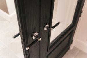 Black leather door lever in bright chrome
