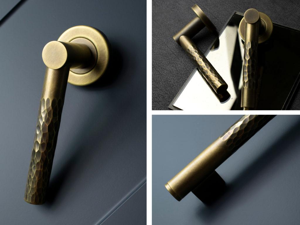 A set of three images showing Turnstyle Designs latest Part Hammered door lever and coffin leg cabinet pull in a deep brown burnished brass finish. Both the door lever and cabinet pull are sat on deep navy coloured cabinet doors.