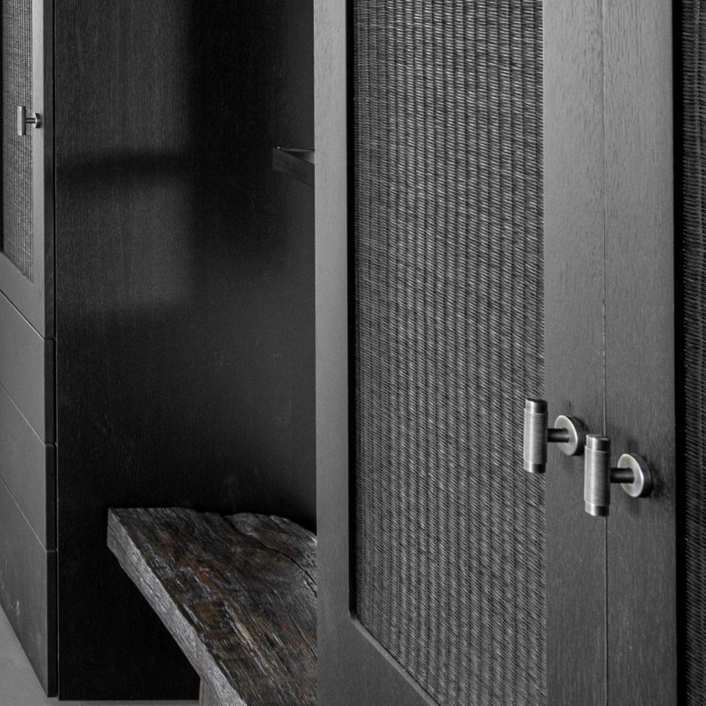 Turnstyle Designs wire design has been used on this dark, masculine style wardrobes. Wire, a very industrial style grip design. works perfectly within this interior.