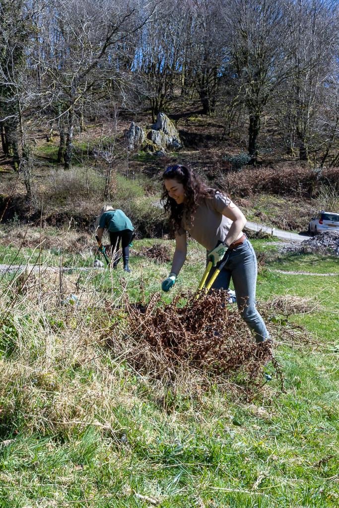 Two young women join the colunteer group at Ashcombe Gardens, helping to manage and maintain the beautiful wild garden there. They are helping clear a large gully of debris to allow for water to drain freely into the stream.