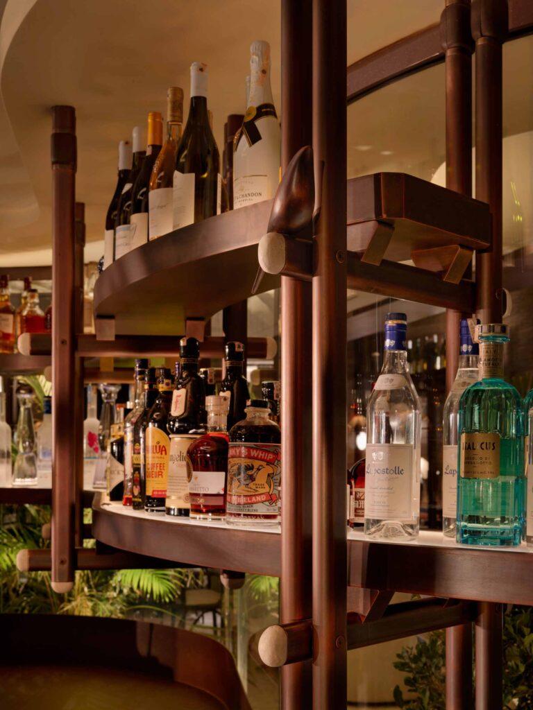 A shelf from a fine dining restaurant showing all sorts of hard liquors and spirits.